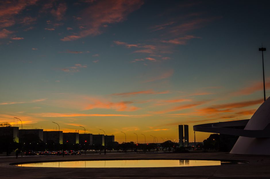 Stunning sunset view highlighting Brasília's unique modern architecture and reflecting pool.