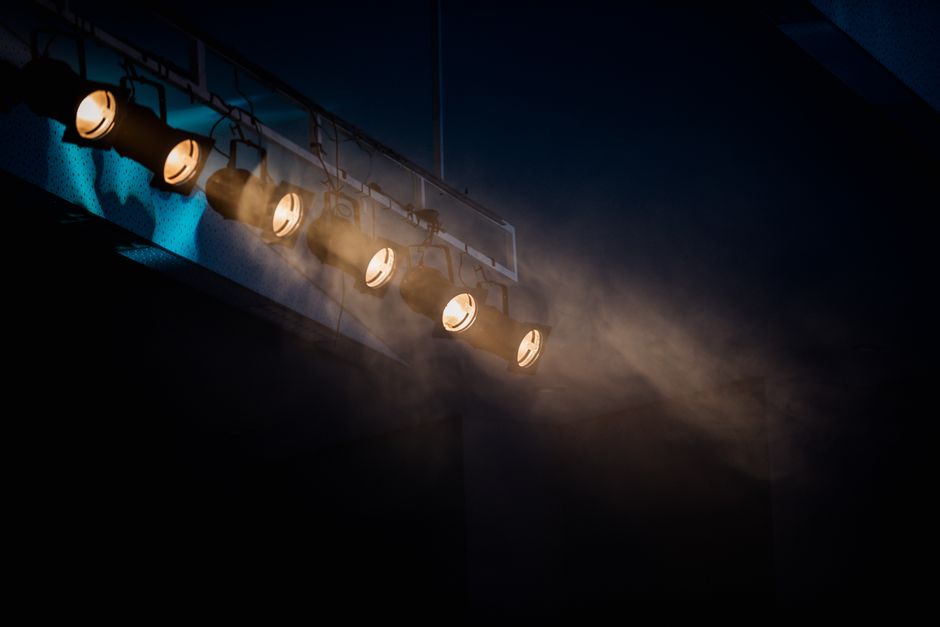 Moody stage lighting with smoke effect to add atmospheric drama.