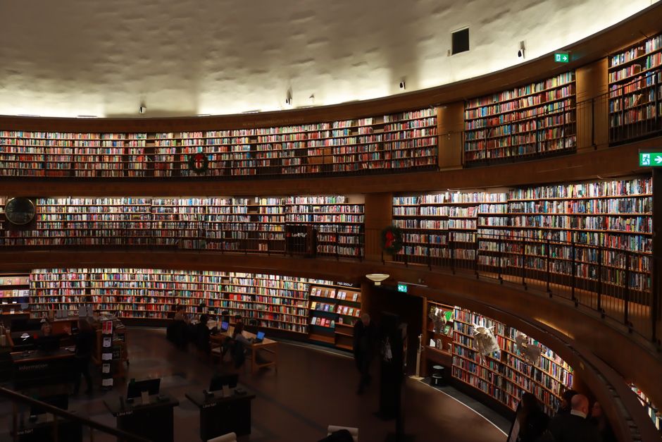 A vast collection of books lining the shelves of Stockholm's iconic public library.