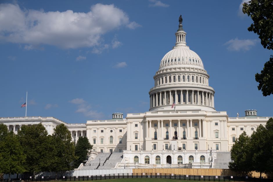 The United States Capitol under clear blue skies, showcasing its iconic architecture.