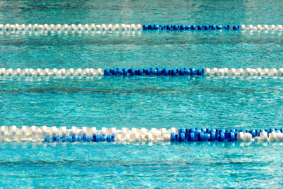 Vibrant swimming pool with blue and white lane dividers, ideal for competitions.