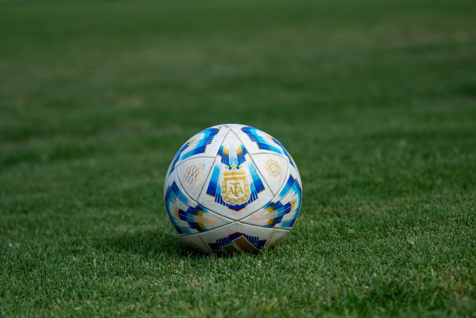 Close-up of a soccer ball on a grassy field, perfect for sports-themed designs.