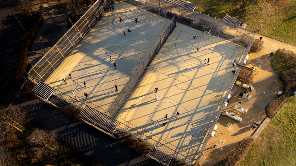 Aerial shot of basketball courts with players in Frankfurt, Germany during the day.