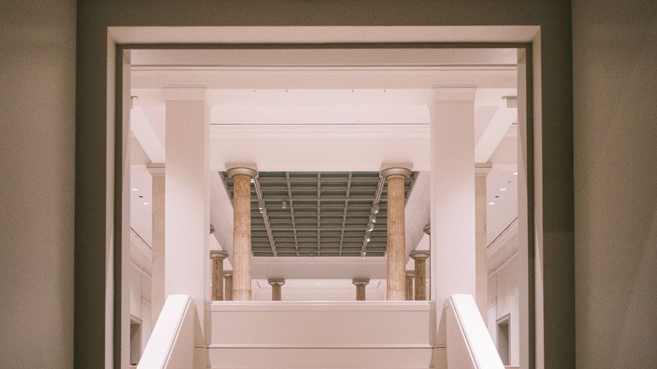 View of a classic interior with marble columns and symmetrical design.